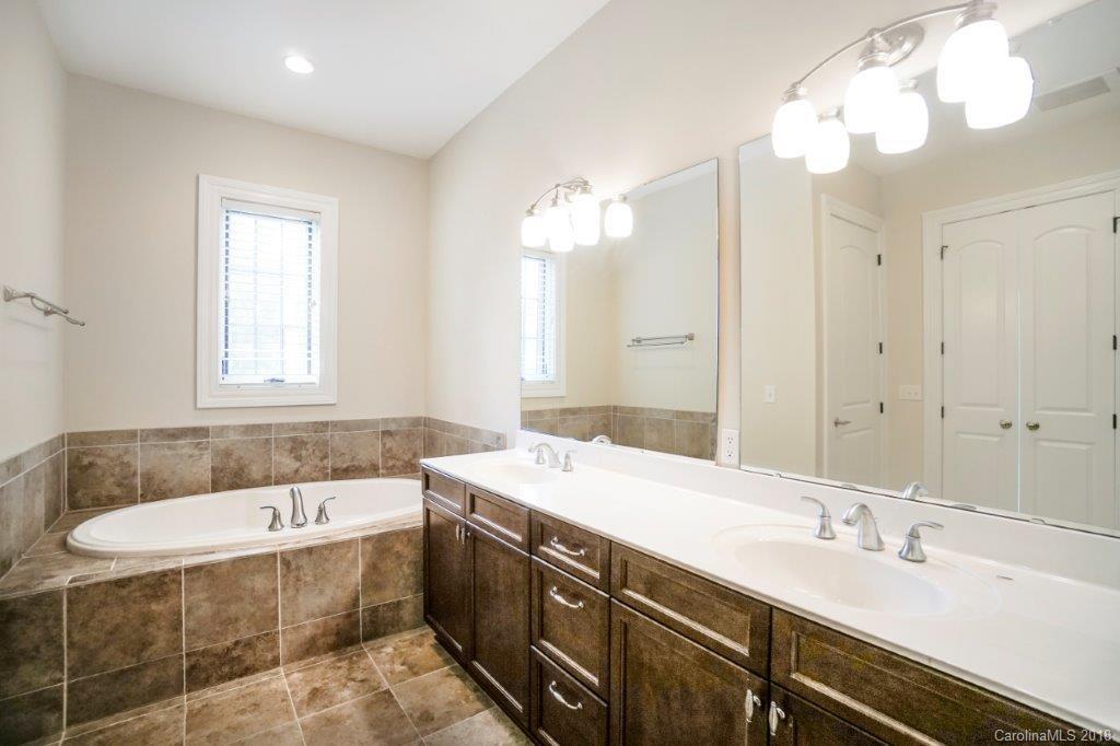 3272 Park Road Charlotte, NC 28209 - Photo 18 of 31 a bathroom with a tub sink and mirror