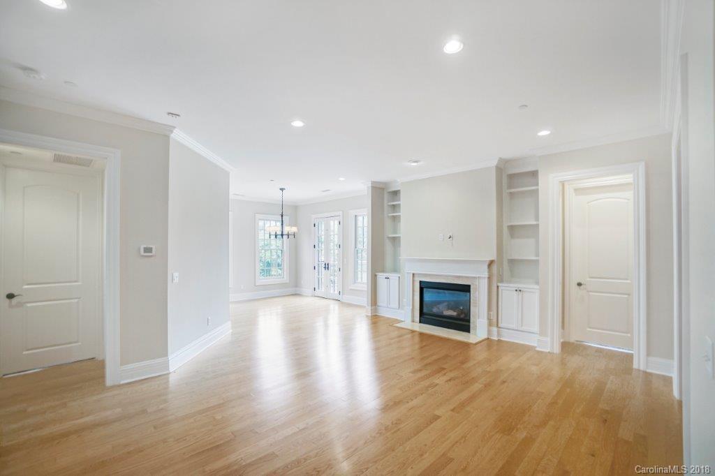 3272 Park Road Charlotte, NC 28209 - Photo 8 of 31 an empty room with wooden floor fireplace and cabinet