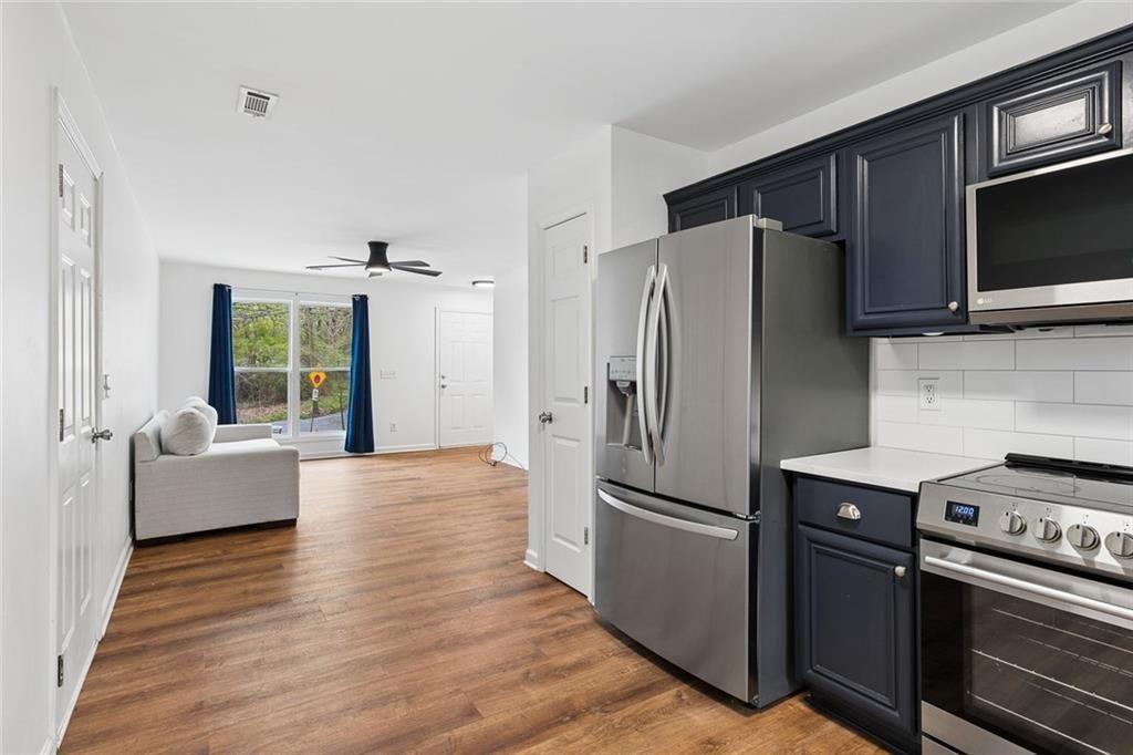 67 Johnson Road Northwest Atlanta, GA 30318 - Photo 15 of 31 a kitchen with stainless steel appliances a refrigerator stove and microwave