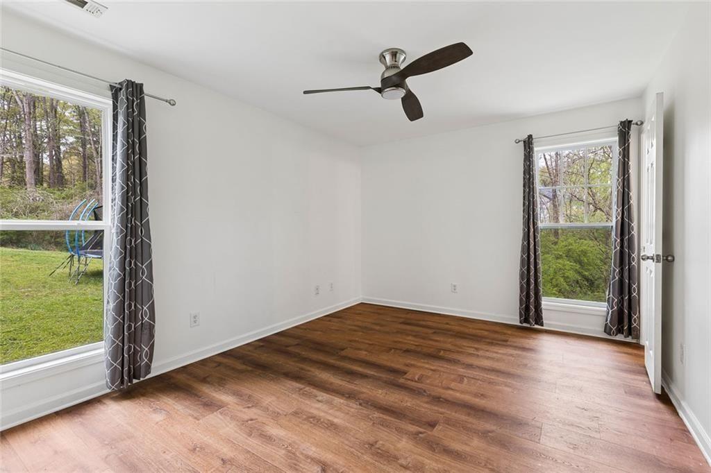 67 Johnson Road Northwest Atlanta, GA 30318 - Photo 19 of 31 wooden floor in an empty room with a window
