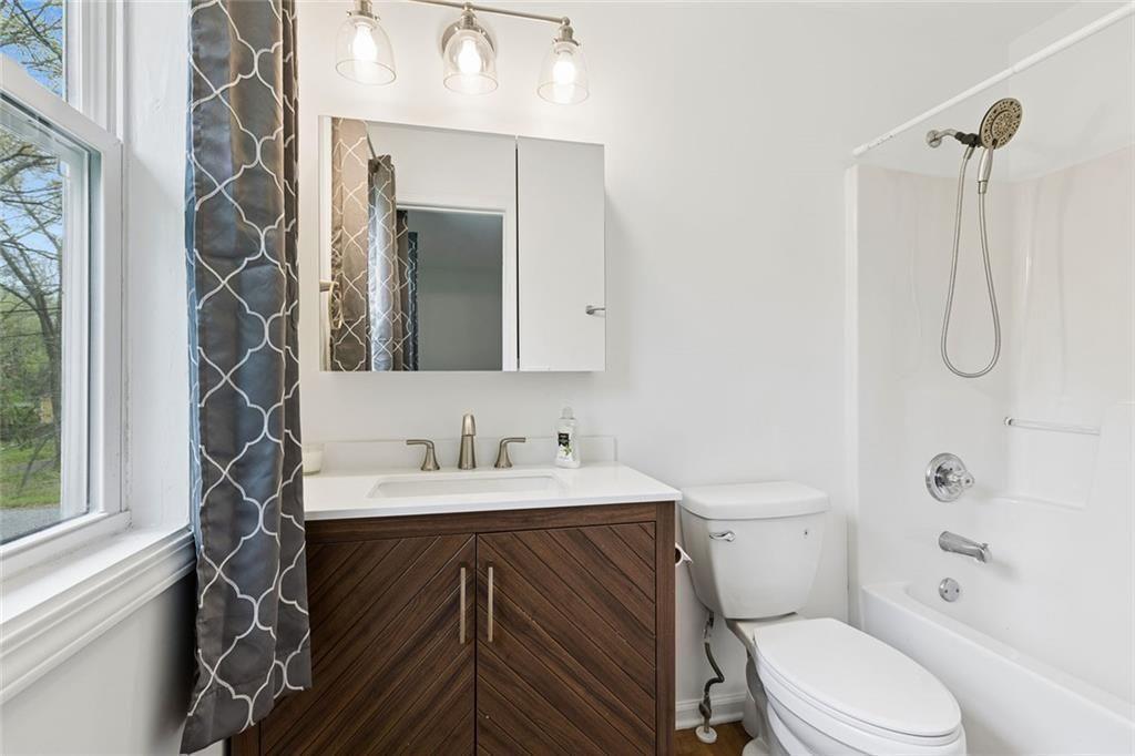 67 Johnson Road Northwest Atlanta, GA 30318 - Photo 27 of 31 a bathroom with a sink a toilet and shower