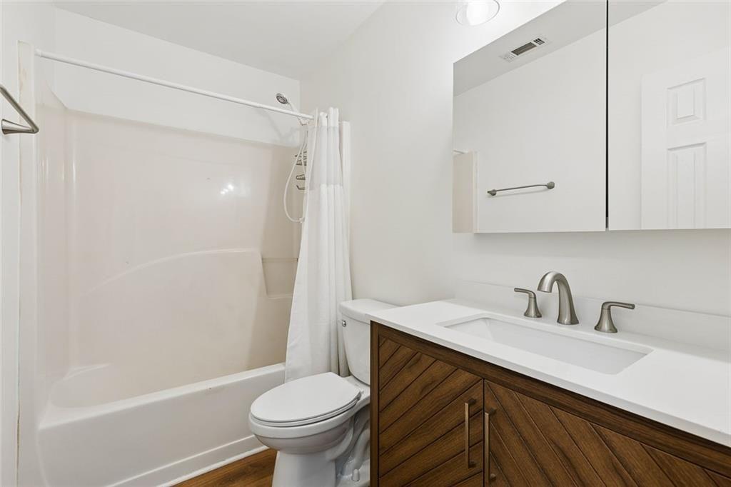 67 Johnson Road Northwest Atlanta, GA 30318 - Photo 28 of 31 a bathroom with a sink a toilet and shower
