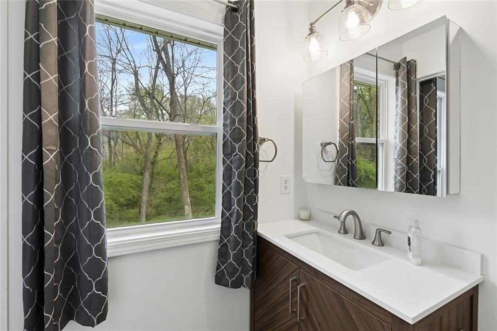 67 Johnson Road Northwest Atlanta, GA 30318 - Photo 29 of 31 a bathroom with a sink vanity and a mirror