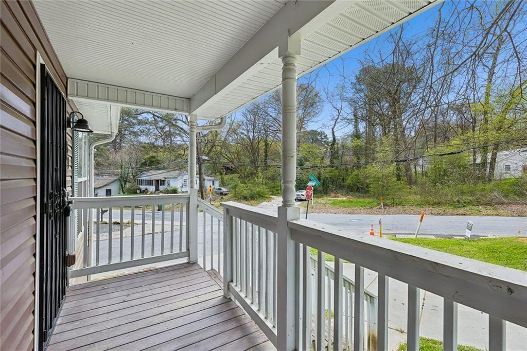 67 Johnson Road Northwest Atlanta, GA 30318 - Photo 5 of 31 a view of a porch with wooden floor and fence
