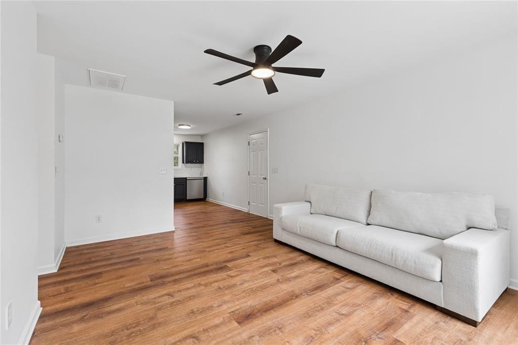 67 Johnson Road Northwest Atlanta, GA 30318 - Photo 8 of 31 a living room with furniture and a ceiling fan