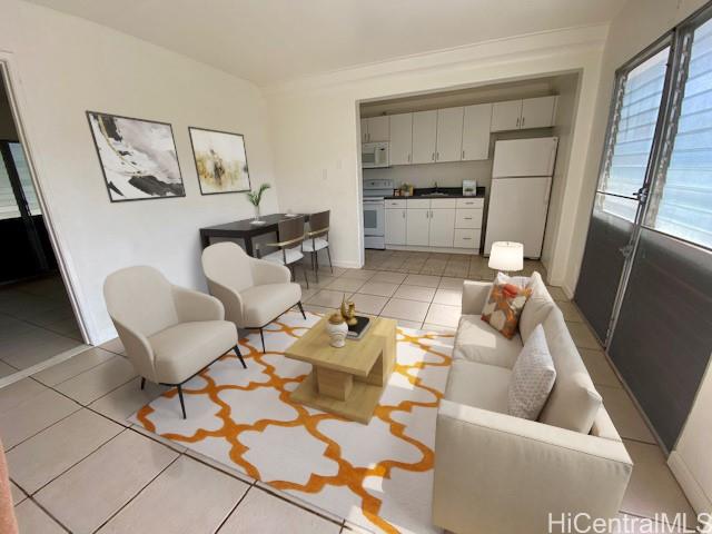 a living room with furniture and kitchen view