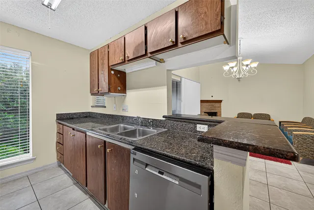 a kitchen with a sink a counter top space cabinets and appliances