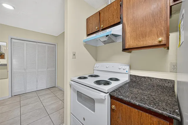 a kitchen that has a sink a stove and a refrigerator