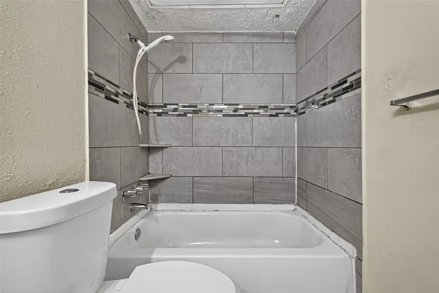 a view of a bathroom with a glass door and shower