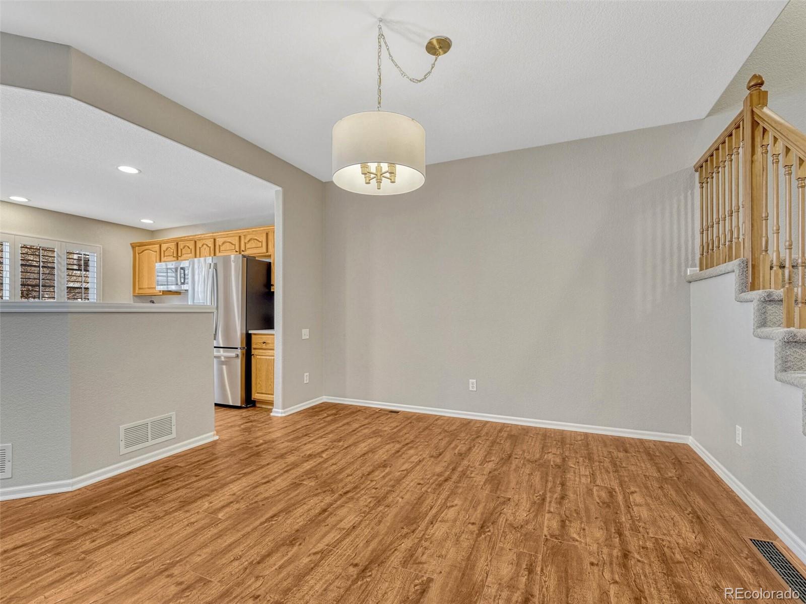 6109 Trailhead Road Highlands Ranch, CO 80130 - Photo 11 of 35 a view of an empty room with wooden floor and a window