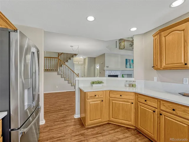 a kitchen with stainless steel appliances granite countertop a refrigerator and a stove top oven