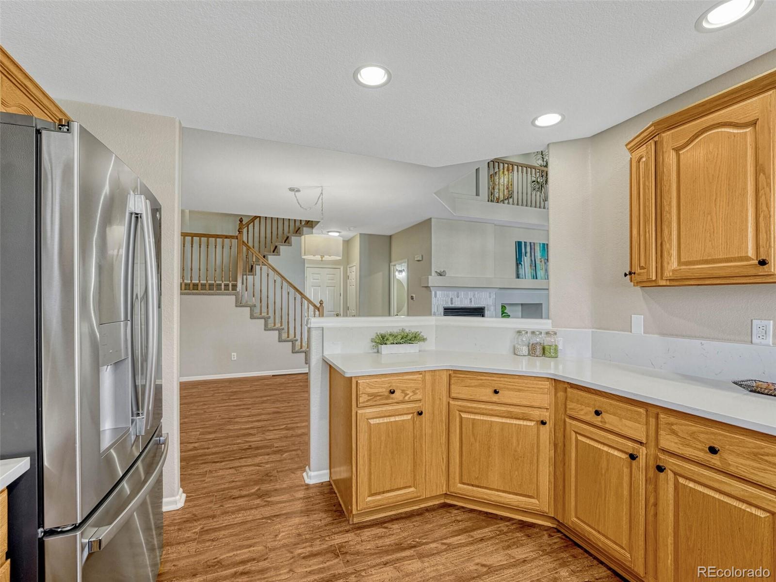 6109 Trailhead Road Highlands Ranch, CO 80130 - Photo 14 of 35 a kitchen with stainless steel appliances granite countertop a refrigerator and a stove top oven