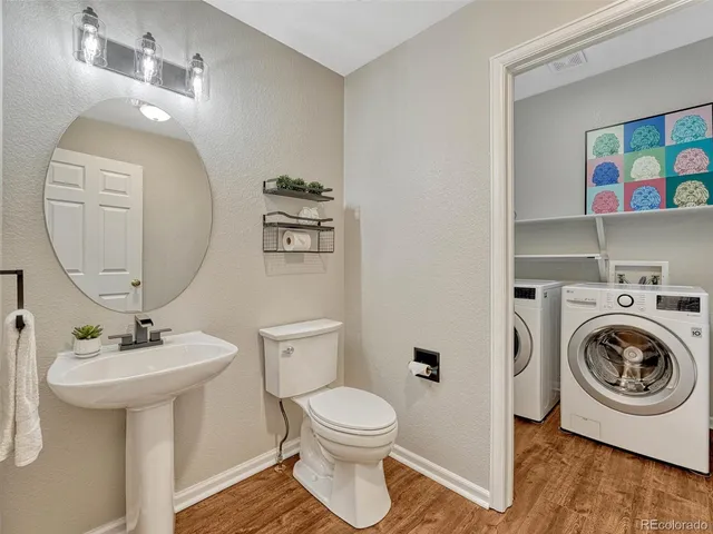 a bathroom with a toilet a sink and a mirror