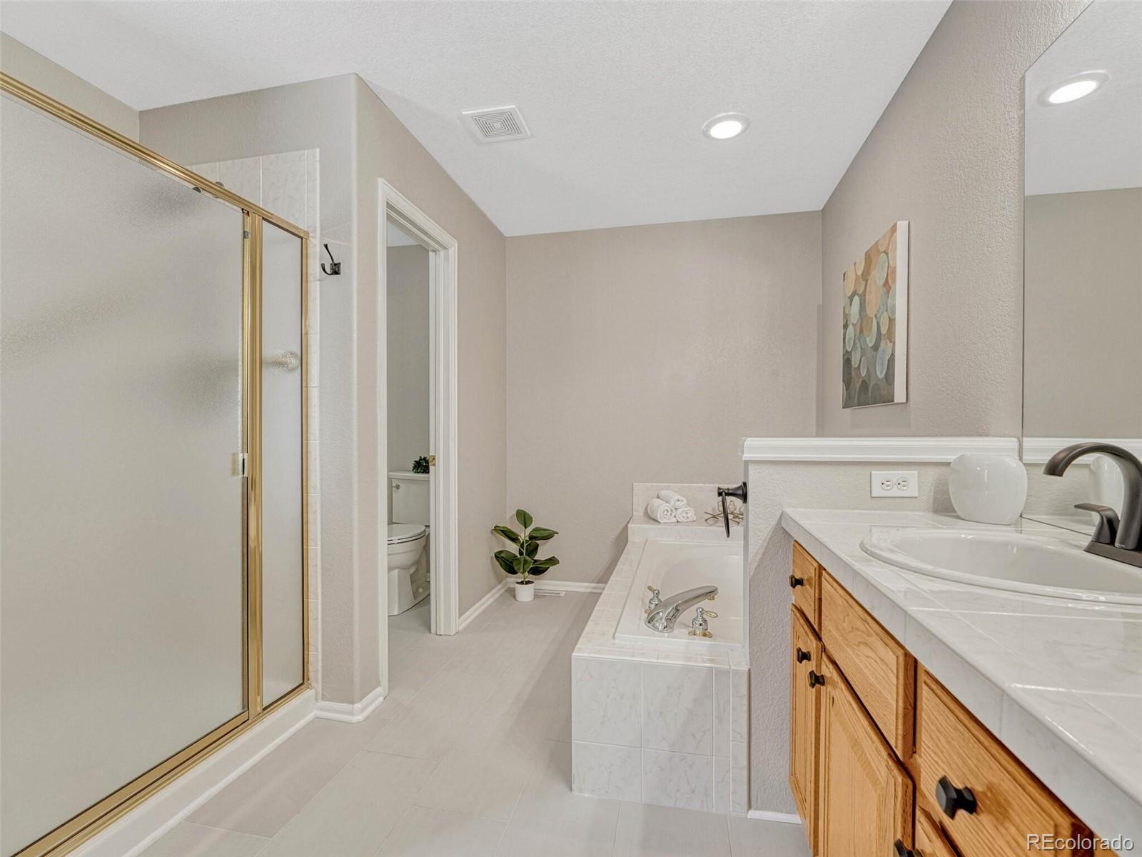 6109 Trailhead Road Highlands Ranch, CO 80130 - Photo 24 of 35 a bathroom with a tub sink and mirror