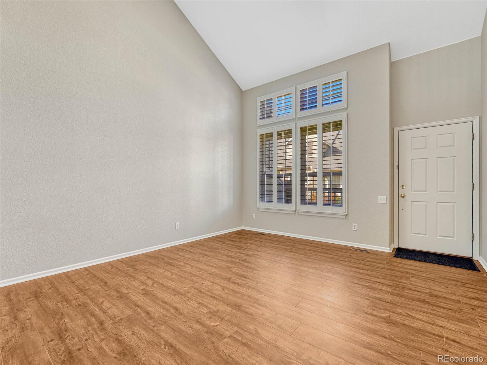 6109 Trailhead Road Highlands Ranch, CO 80130 - Photo 9 of 35 a view of an empty room with wooden floor and a window