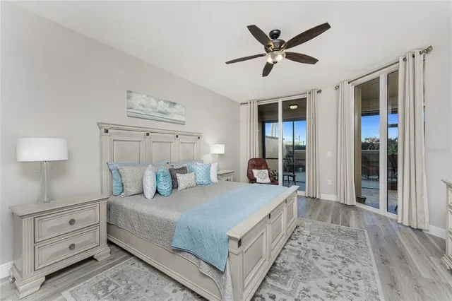 a bedroom with a large bed and a ceiling fan