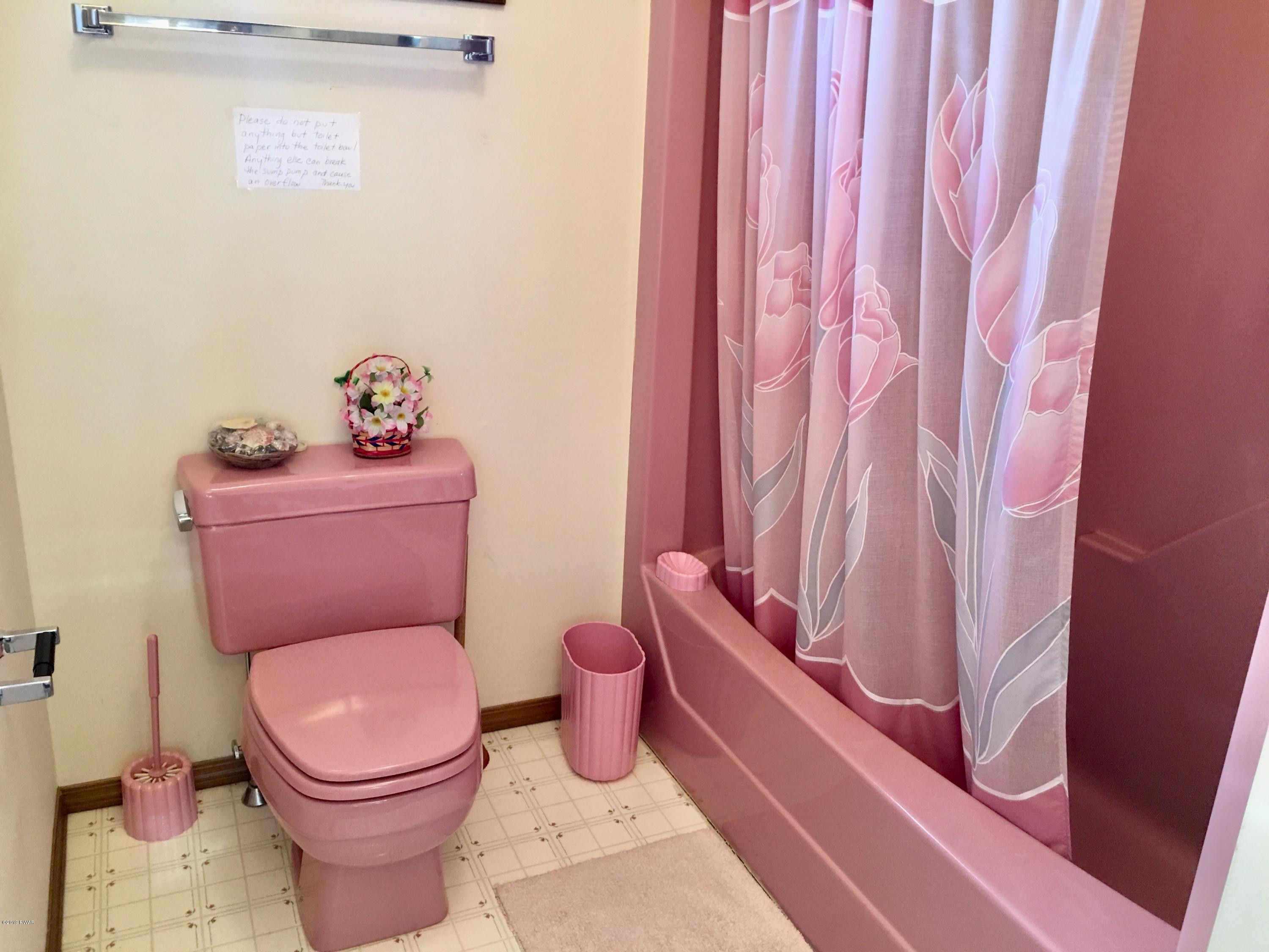 2375 Crest View Road Lake Ariel, PA 18436 - Photo 25 of 30 a white toilet sitting next to a shower curtain
