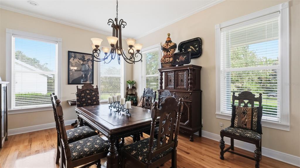 23337 Lake Lindsey Road Brooksville, FL 34601 - Photo 12 of 59 a view of a dining room with furniture window and wooden floor