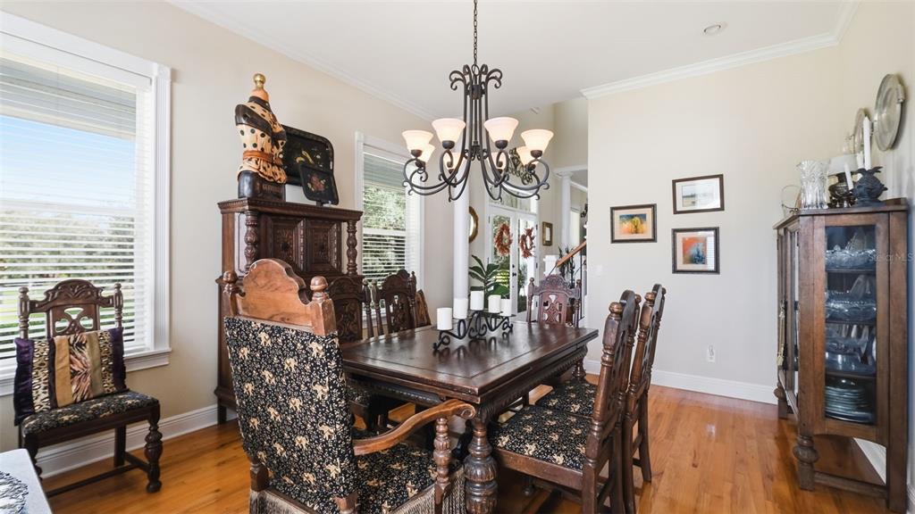 23337 Lake Lindsey Road Brooksville, FL 34601 - Photo 13 of 59 a view of a dining room with furniture and wooden floor