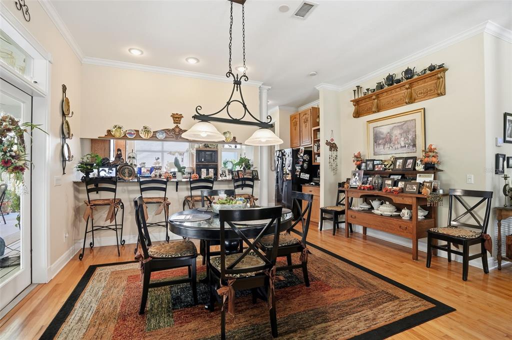23337 Lake Lindsey Road Brooksville, FL 34601 - Photo 20 of 59 a view of a dining room with furniture and wooden floor