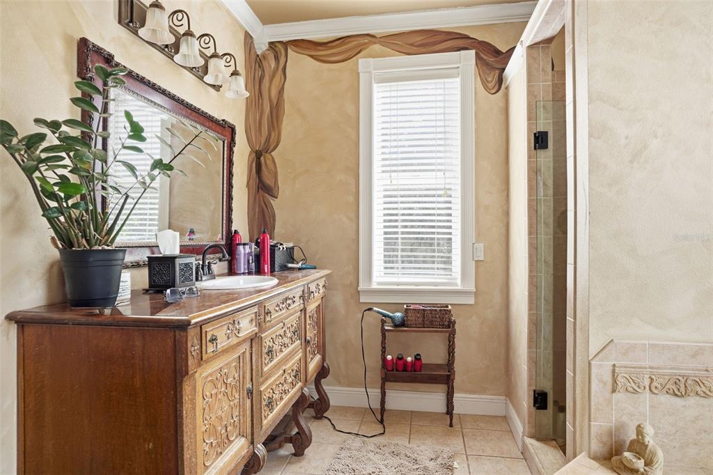 23337 Lake Lindsey Road Brooksville, FL 34601 - Photo 31 of 59 a bathroom with a sink a mirror and a window