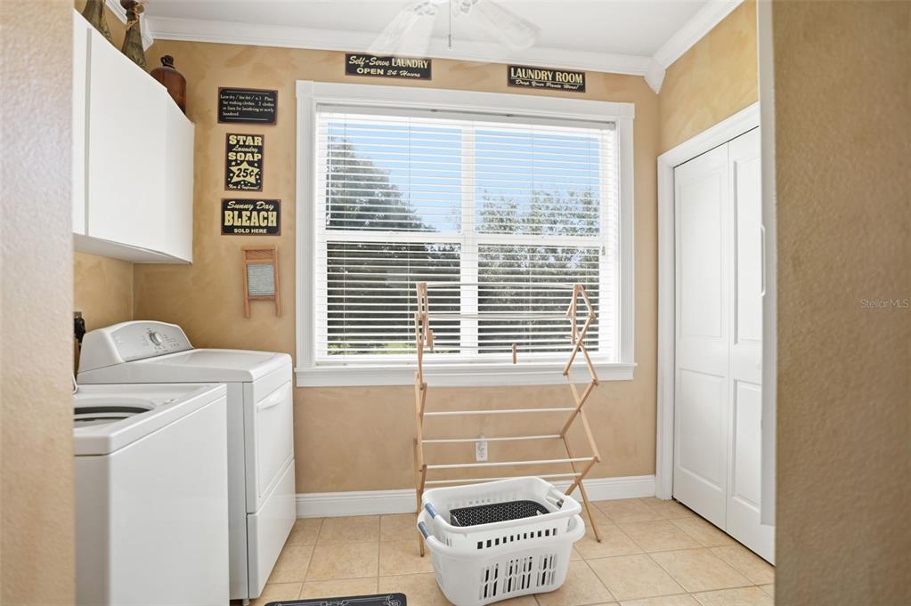 23337 Lake Lindsey Road Brooksville, FL 34601 - Photo 32 of 59 a bathroom with a window a toilet and a shower