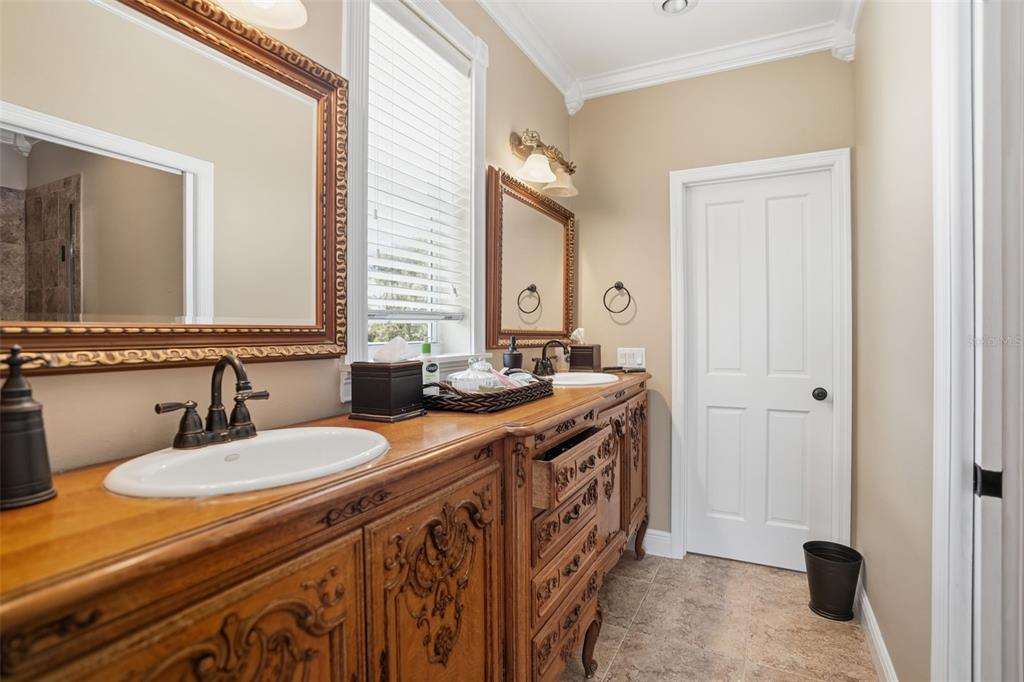 23337 Lake Lindsey Road Brooksville, FL 34601 - Photo 36 of 59 a spacious bathroom with a sink double vanity and a mirror