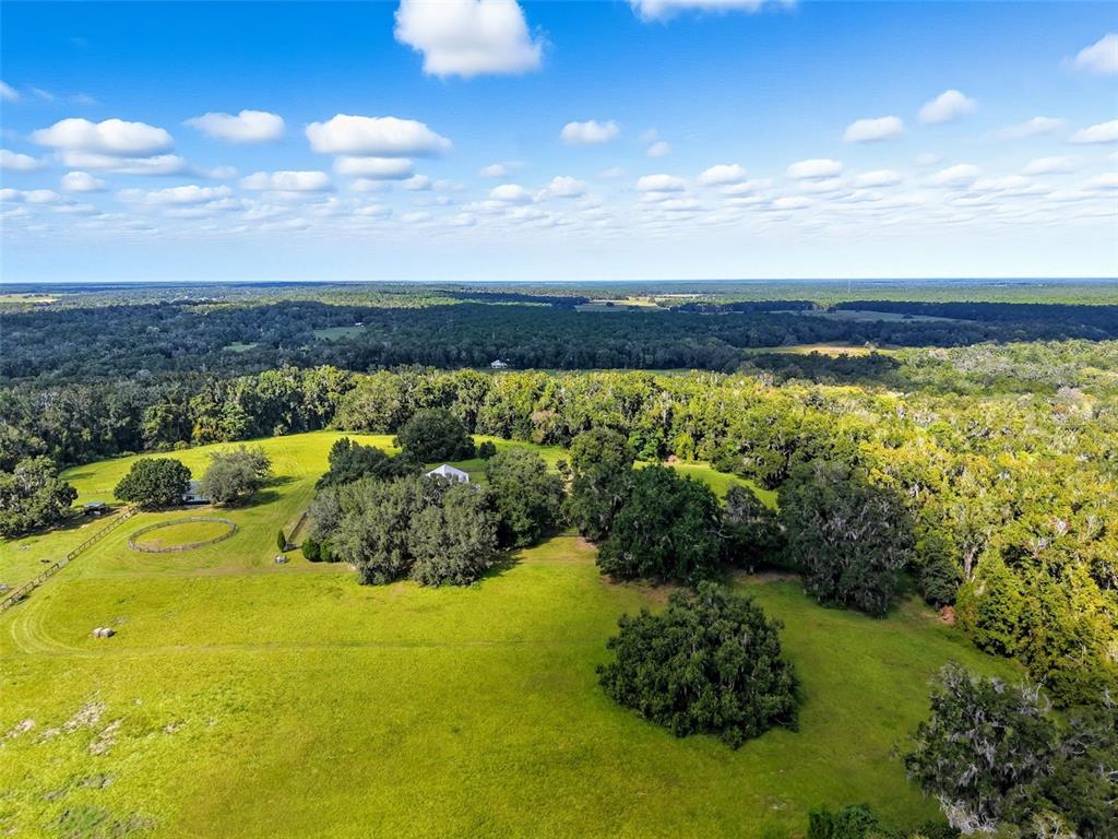 23337 Lake Lindsey Road Brooksville, FL 34601 - Photo 49 of 59 a view of a lake with a house in the background