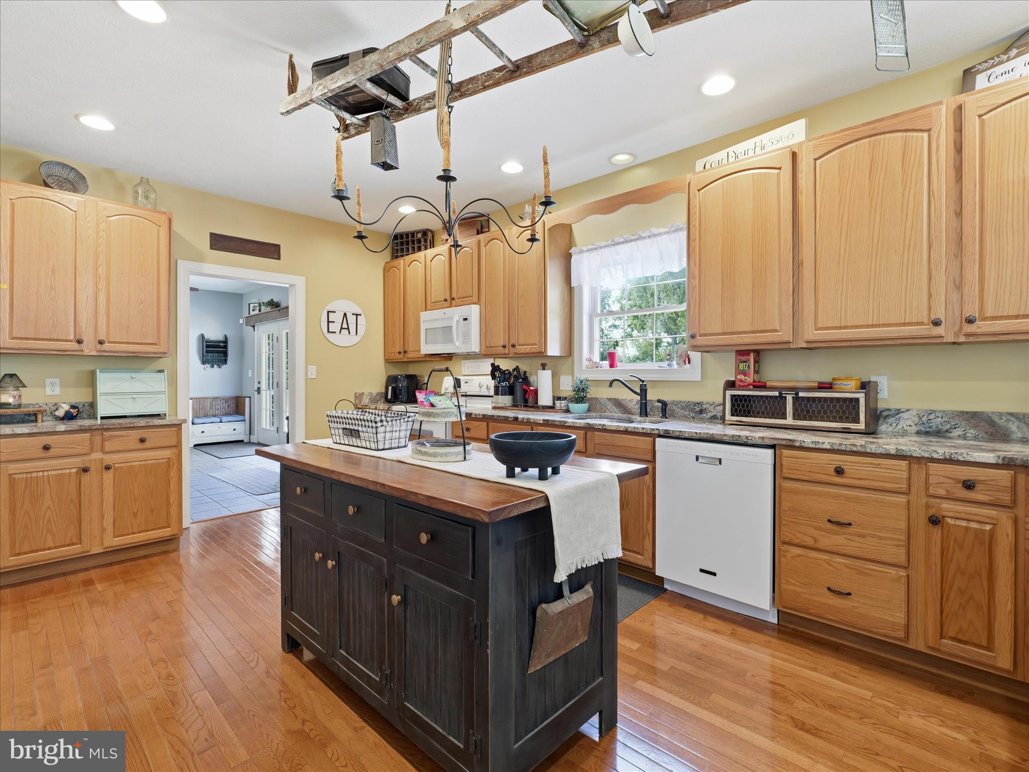 726 Doe Run Road Inwood, WV 25428 - Photo 25 of 68 a kitchen with stainless steel appliances granite countertop a stove a sink dishwasher a refrigerator and white cabinets with wooden floor