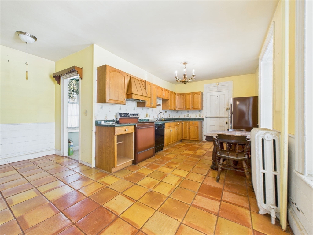 181 Washington Street Fairhaven, MA 02719 - Photo 34 of 41 a kitchen with stainless steel appliances granite countertop a refrigerator and a stove top oven