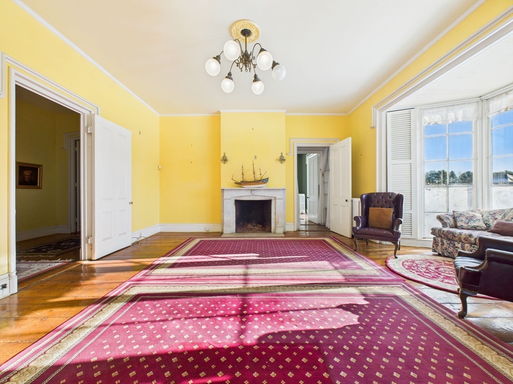 181 Washington Street Fairhaven, MA 02719 - Photo 7 of 41 a bedroom with a bed and a chandelier