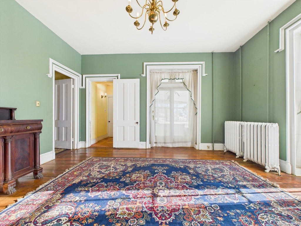 181 Washington Street Fairhaven, MA 02719 - Photo 9 of 41 a view of a livingroom with wooden floor and a window