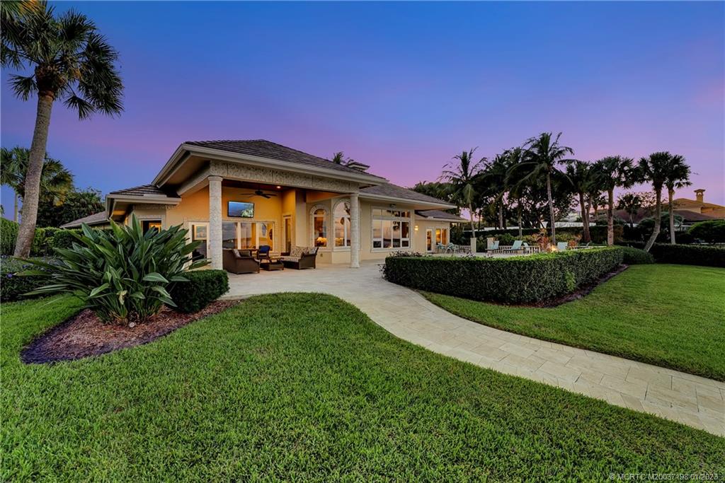 825 Southeast Riverside Drive Stuart, FL 34994 - Photo 75 of 96 a front view of a house with a garden
