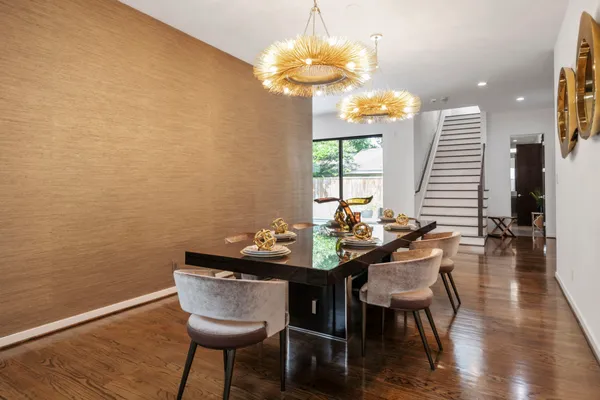 a dining room with furniture and wooden floor