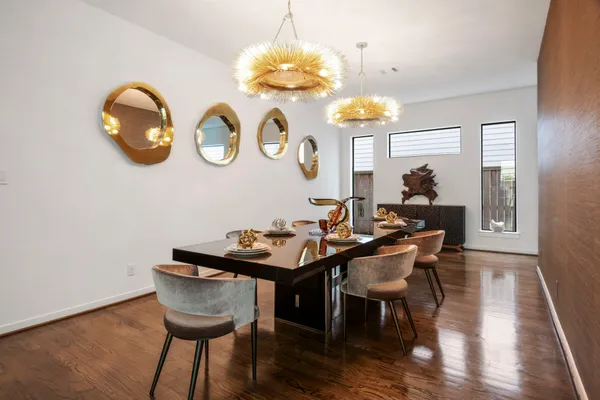 a view of a dining room with furniture and chandelier
