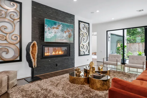 a living room with furniture a rug and white walls