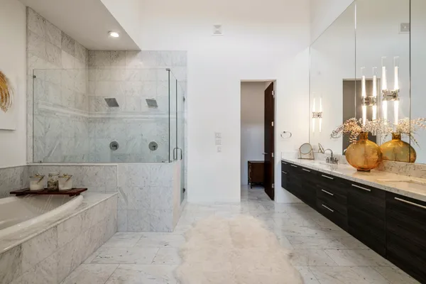 a bathroom with a tub sink and mirror