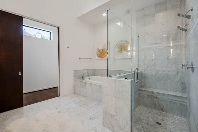 a bathroom with a bathtub and a shower