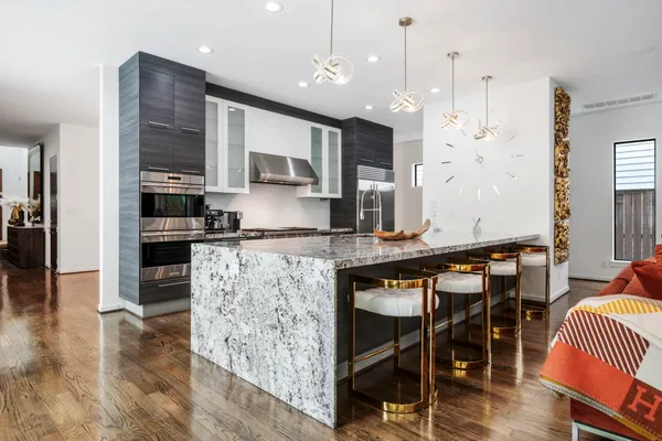 a kitchen with stainless steel appliances granite countertop a stove refrigerator and cabinets
