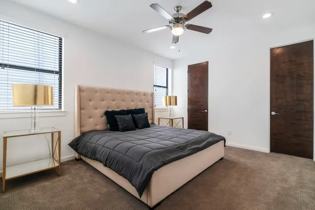 a bedroom with a large bed and a chandelier