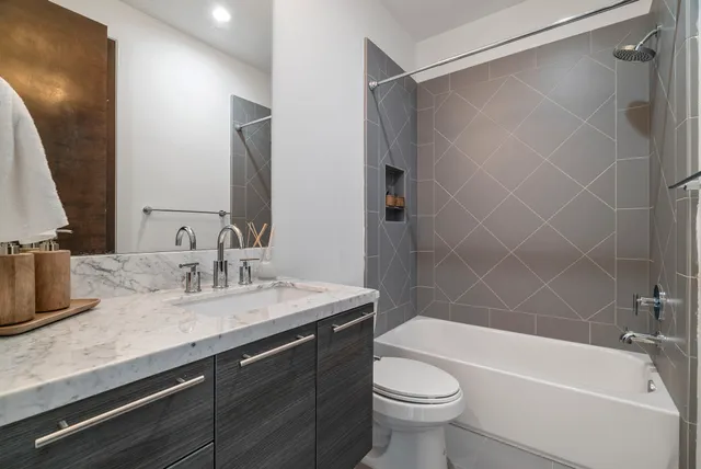 a bathroom with a sink a toilet and a bathtub