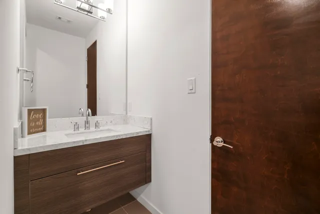 a bathroom with a double vanity sink and mirror