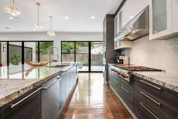 a large kitchen with stainless steel appliances granite countertop a large stove a sink and dishwasher