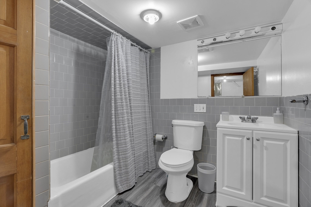 64 Commonwealth Road Watertown, MA 02472 - Photo 15 of 23 a bathroom with a toilet sink and shower