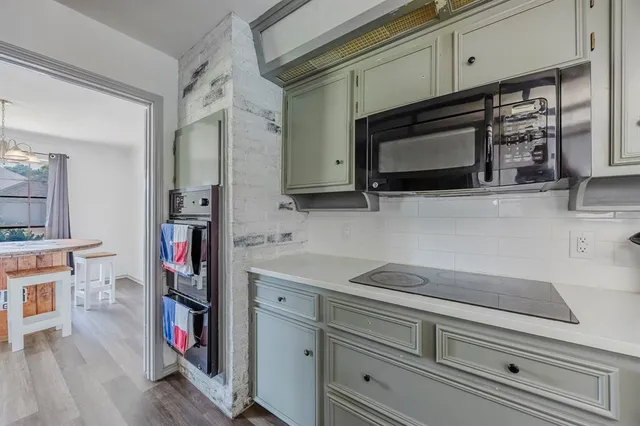 a kitchen with stainless steel appliances white cabinets and a stove