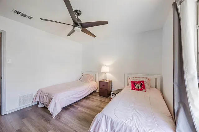 a bedroom with two bed and a closet