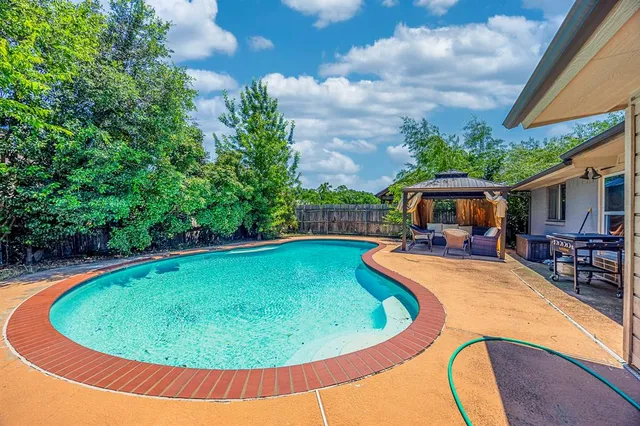a view of swimming pool with seating space
