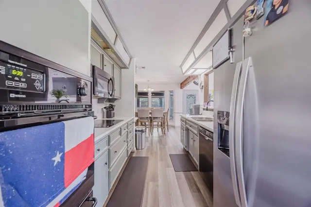 a kitchen with stainless steel appliances granite countertop lots of counter top space and cabinets