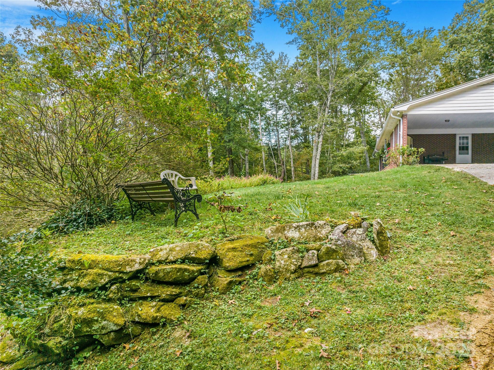 679 Solomon Jones Road Cedar Mountain, NC 28718 - Photo 17 of 47 a backyard of a house with table and chairs