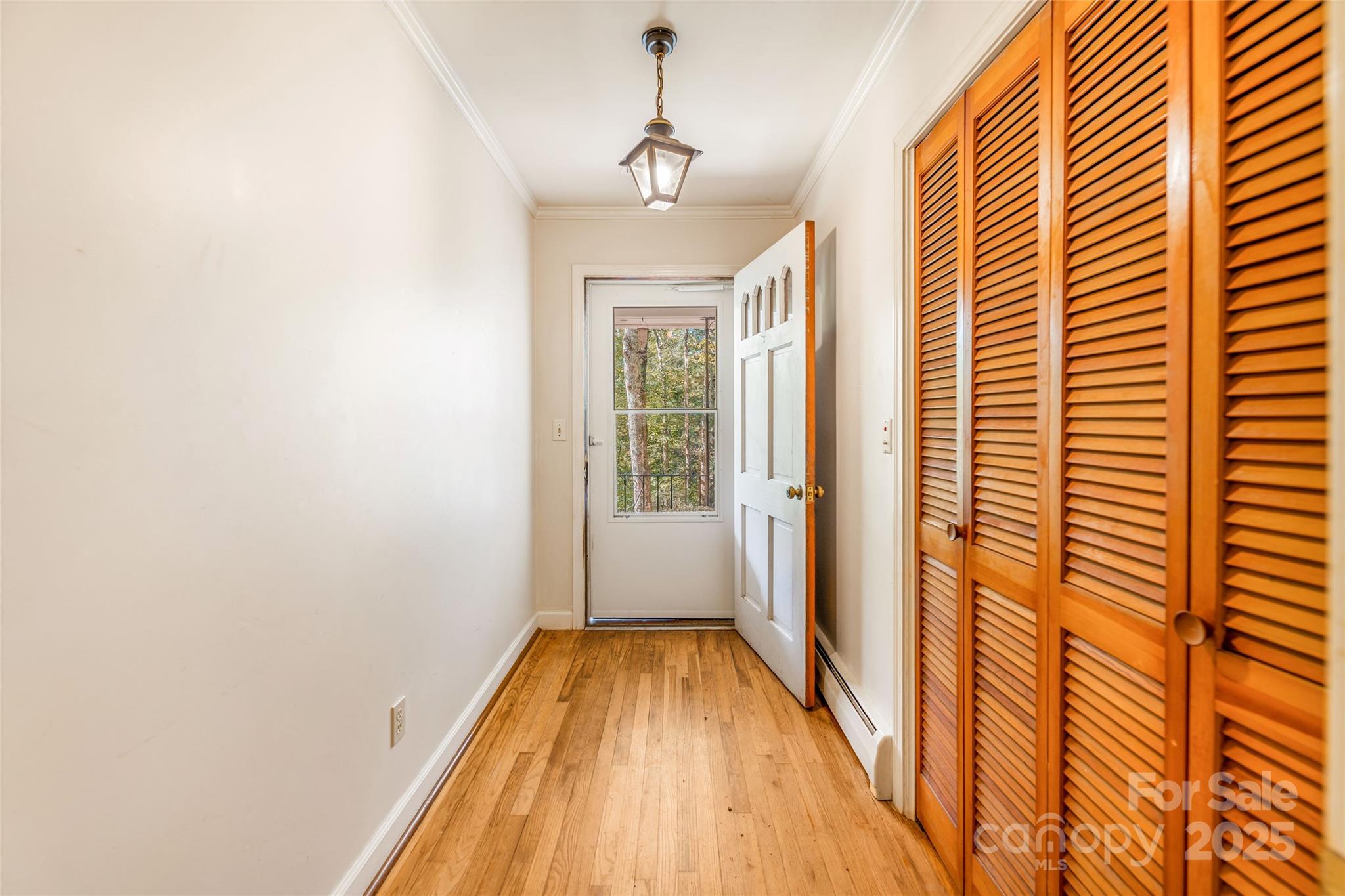 679 Solomon Jones Road Cedar Mountain, NC 28718 - Photo 20 of 47 a view of a hallway with wooden floor and staircase